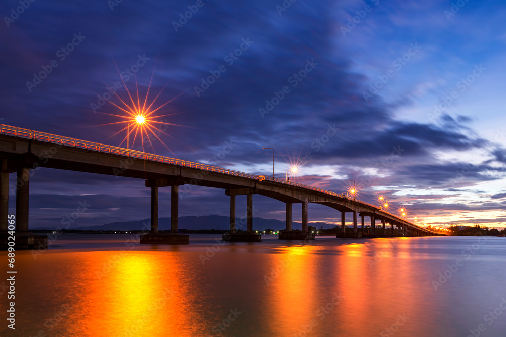 View beautiful of Bridge crossing the sea with dramatic sunrise sky. It is a approximately 1 km long bridge on Taksin Maharat Bridge in Chanthaburi Province of Eastern Thailand.