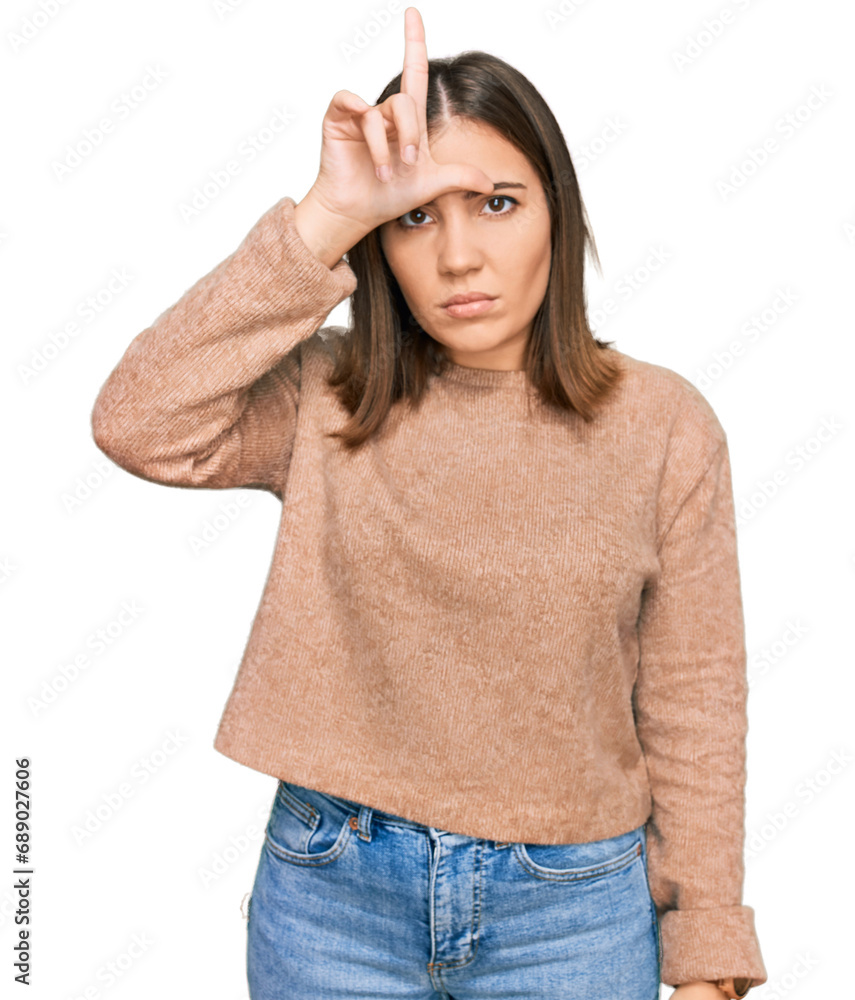 Fototapeta premium Young beautiful woman wearing casual clothes making fun of people with fingers on forehead doing loser gesture mocking and insulting.