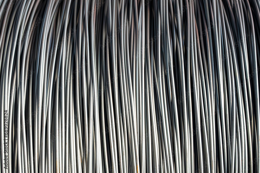 Fototapeta premium Pile of iron, metal or steel wire rod or coil background for Construction industry. steel wire fence rolls. Steel wire tie rolls for construction and industrial. Coil of iron or steel background.