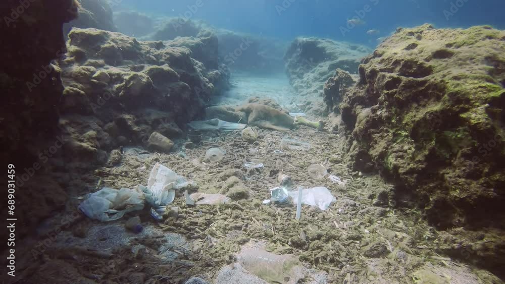 Rocky seabed polluted with plastic and other waste Rocky seabed polluted with plastic and other waste