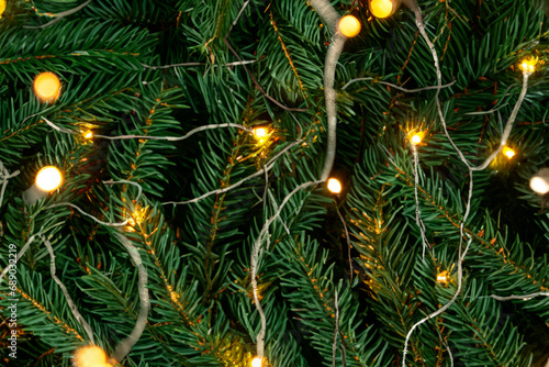 Christmas tree. Christmas tree branches with yellow bright garlands, close-up. festive atmosphere concept