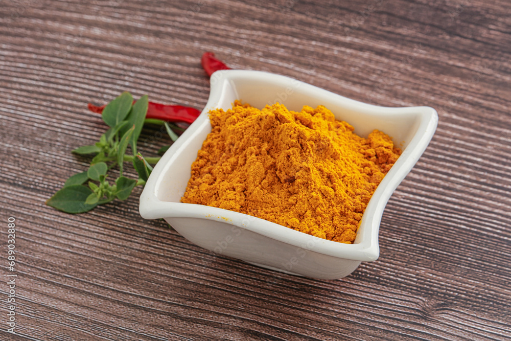 Yellow vibrant curcuma powder in the bowl Yellow vibrant curcuma powder in the bowl