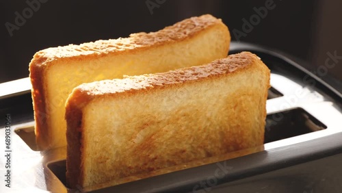 Appetizing golden slices of toasted bread emerge from the toaster oven. Slowly the toast jumps. Breakfast. In the sunny morning light,