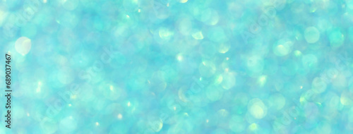 Blurred shiny turquoise background with sparkling lights. photo