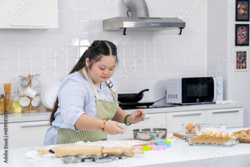 A girl practicing cooking in the kitchen at home.