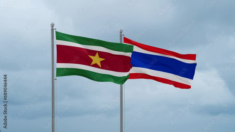 Kingdom of Thailand and Suriname flag waving together on cloudy sky, endless seamless loop, two country cooperation concept Kingdom of Thailand and Suriname flag waving together on cloudy sky, endless seamless loop, two country cooperation concept