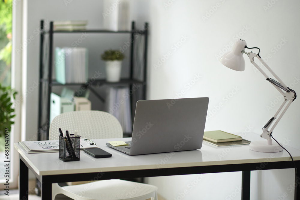 Desk of business person with laptop, lamp and documents Desk of business person with laptop, lamp and documents