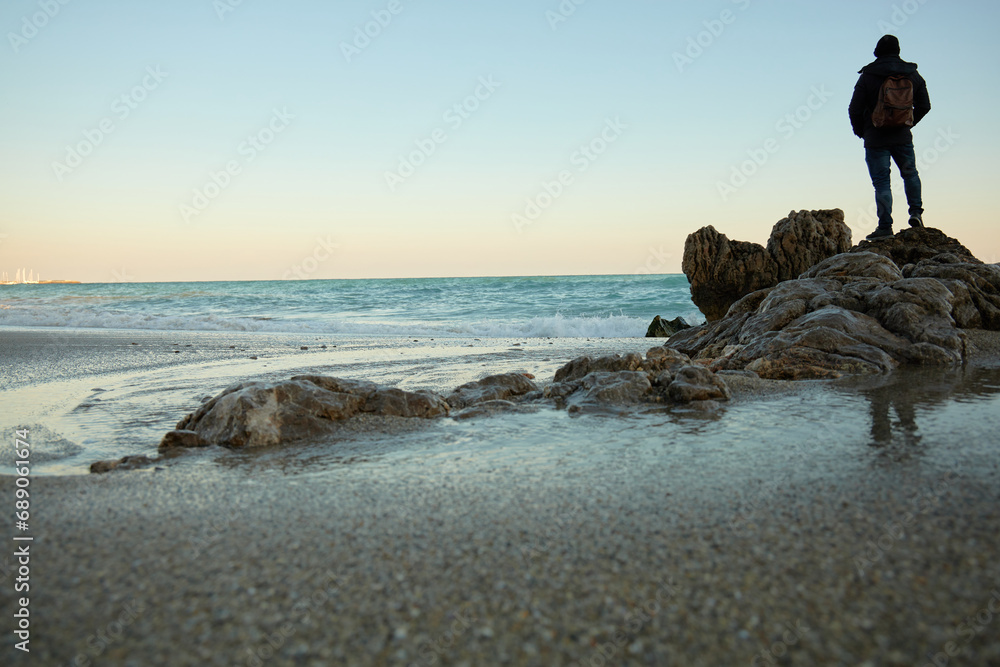 mountain and beach with sand and sea foam
