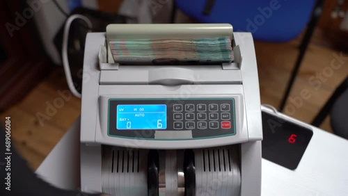 Counting machine for banknotes. Ukrainian money in a calculating machine. Ukrainian hryvnia is counted by a machine for banknotes. 