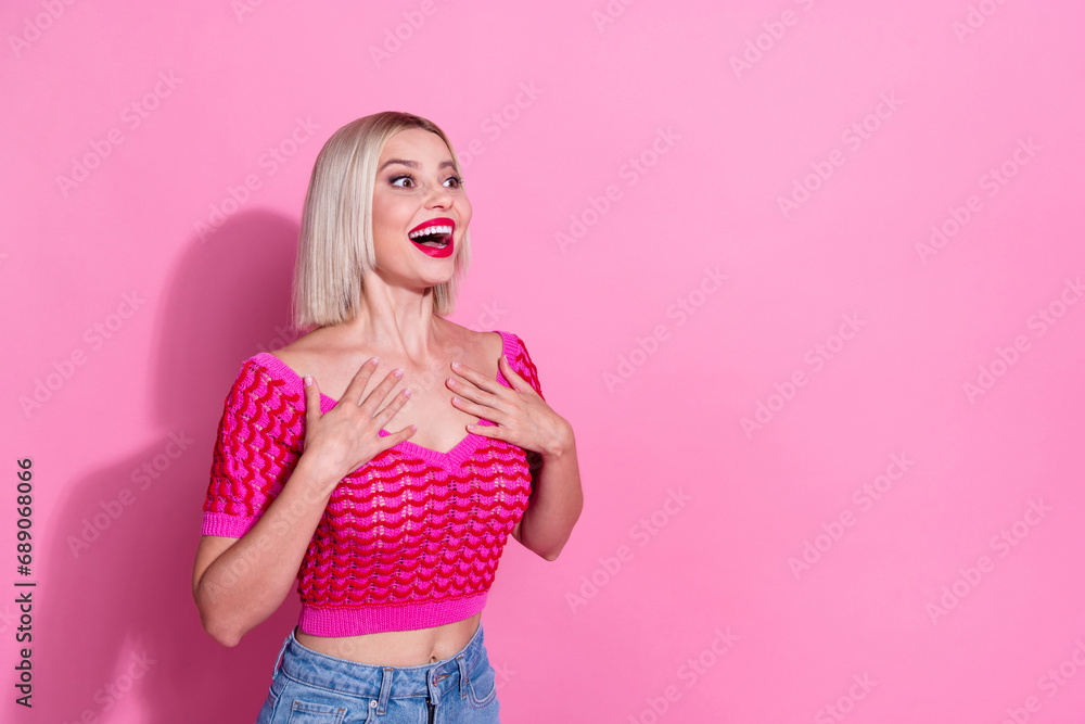 Portrait of astonished lovely girl hands touch chest look empty space ad isolated on pink color background - obrazy, fototapety, plakaty 