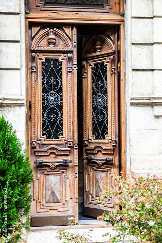 travel to Georgia - open carved wooden entrance door of apartment building in downtown of Batumi city