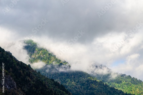travel to Georgia - gray clouds lie on tops of mountains in Machakhela national park in Adjara on autumn day