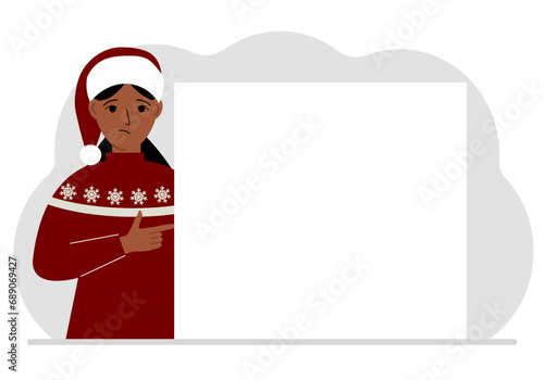 A woman in a red sweater near a large white sheet. Advertising, invitation, discount for Christmas or New Year.