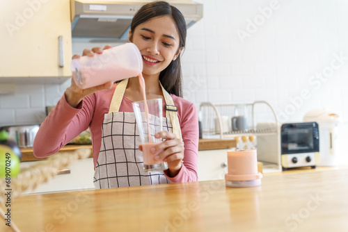 Asian woman making healthy drinking fresh  homemade  in home kitchen counter photo