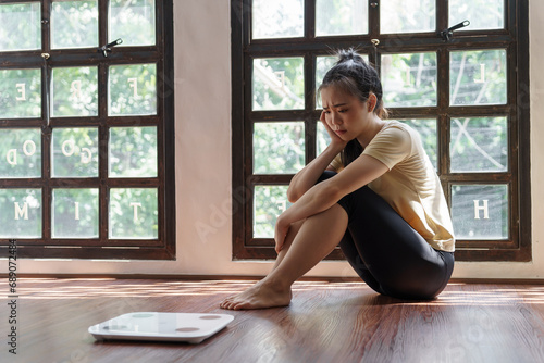 Sad woman with fat upset bored of dieting Weight loss fail Fat diet and scale sad asian woman on weight scale at home weight control Free Download Sad woman with fat upset bored of dieting Weight loss fail Fat diet and scale sad asian woman on weight scale at home weight control - GFXLoad