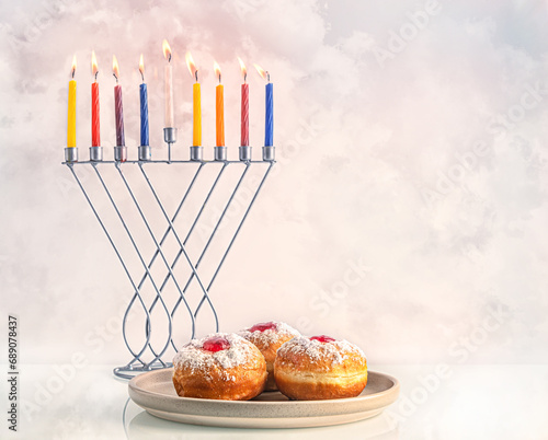 festive hanukkah background with sweet donuts and colorful candles