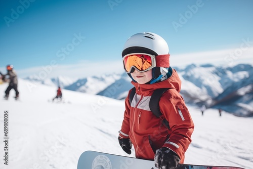 Child on snow slope wearing safety helmet, snowboarding and skiing © Catherine Chin