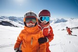 Two kids on winter slope wearing safety goggles. Sports holiday