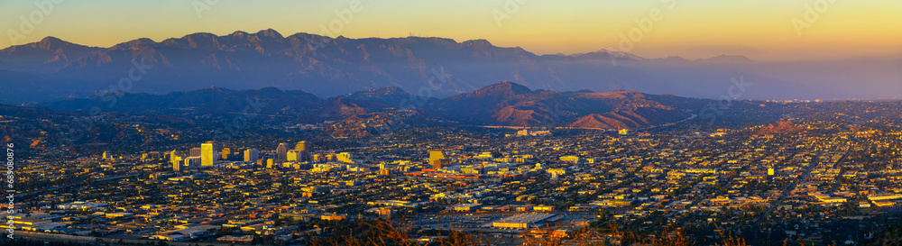 Sunset panorama of downtown Glendale and San Gabriel Mountains in the background viewed from Griffith Park near Los Angeles, California.