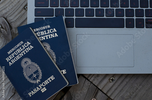 Argentine passport with PC in the background taking out airfare. document to leave the country for travel photo