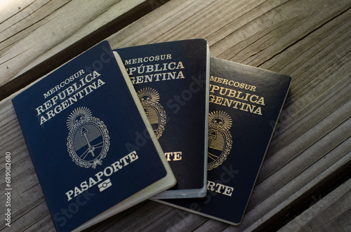 three passports of a family to travel and leave the Argentine Republic on a wooden table photo