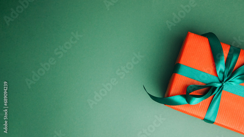 Festive background. Gifts wrapping in red and brown paper on a green background. Top view. Web banner