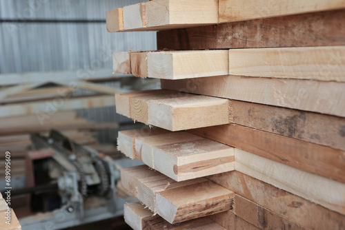 Stacked wooden boards in woodworking industry. Wood harvesting shop. Timber for construction.