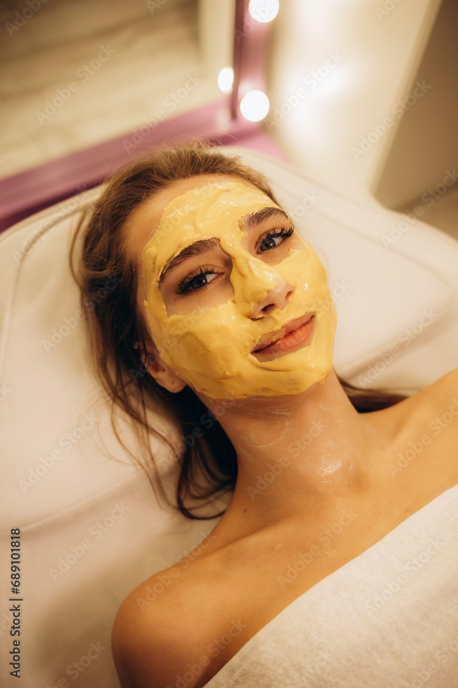 Procedure for skin care. Doctor in cosmetology office applies an yellow