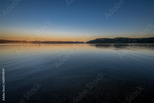 Knysna Lagoon with jetty and fishing boats at sunset in the Garden Route South Africa