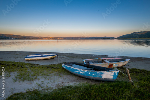 Knysna Lagoon with jetty and fishing boats at sunset in the Garden Route South Africa