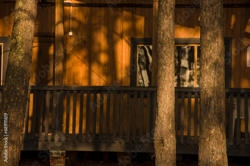 Vertical shot of a wooden faded facade of an old cozy two-storied summer house