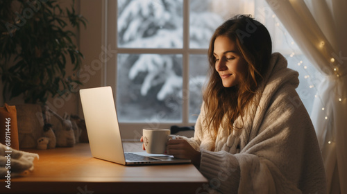 Obraz na płótnie woman with cosy furry blanket working on laptop with coffe mug during winter. w salonie
