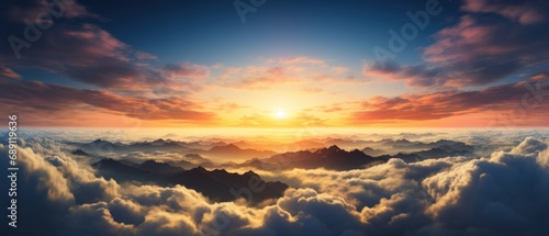 Panorama sunrise from the top of the mount Fuji. The sun is shining strong from the horizon over all the clouds and under the blue sky. good New year new life new beginning. Abstract nature background © Tisha
