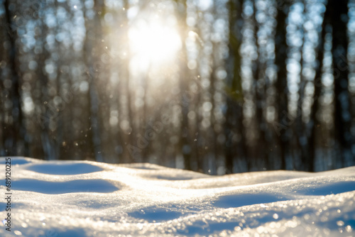 winter season. snowdrifts, glare of the sun through the trees in the background, close-up. winter atmosphere