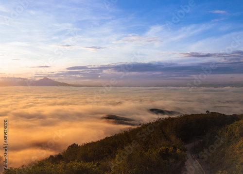Morning mist flows through the mountains. © saksuvan