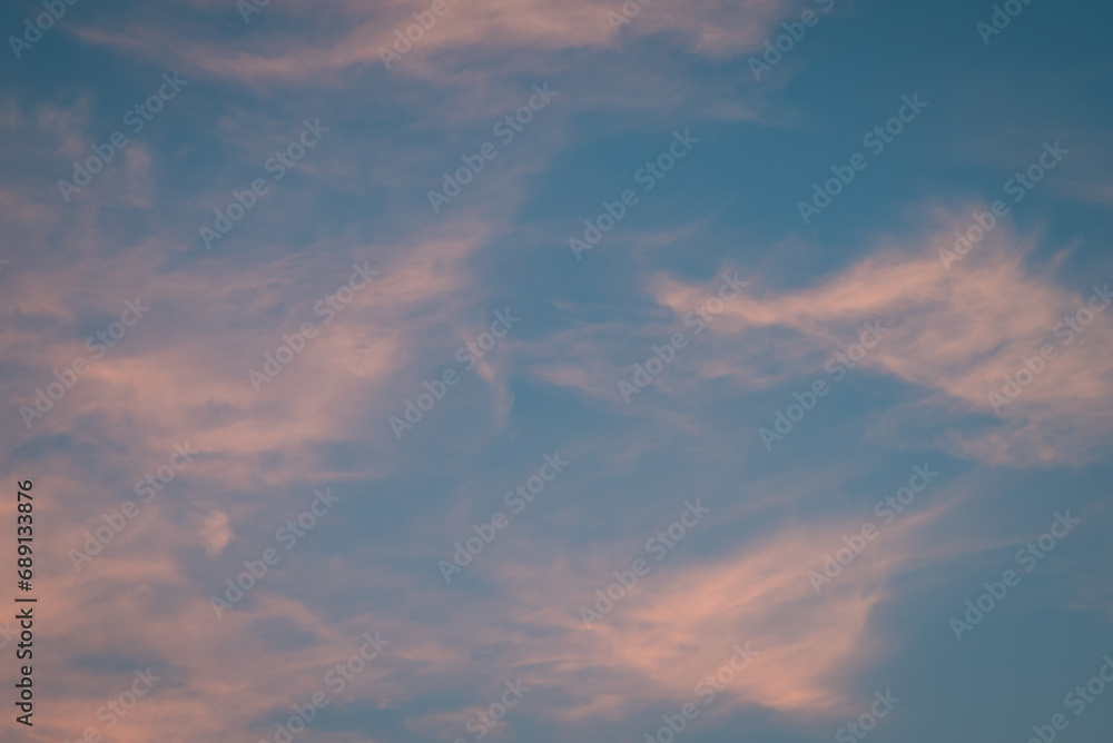 Feather like clouds in sky after sunset. Beautiful evening sky with light clouds
