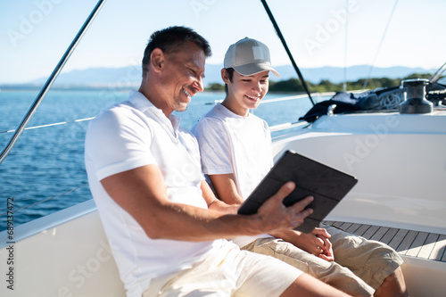Dad and son on the boat spending time together