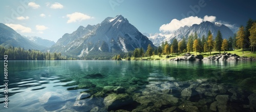 Gorgeous sunlit alpine highlands with majestic rock mountain backdrop and Hintersee lake in Bavarian Alps Germany Creative scenery Copy space image Place for adding text or design photo
