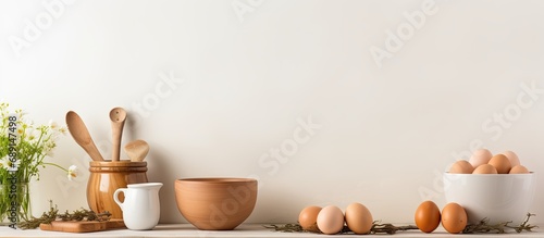 Egg rolling pin bowls and utensils on table Blank space kitchen decor idea Wide banner Copy space image Place for adding text or design photo
