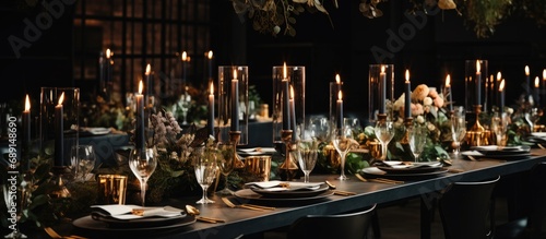 Luxurious wedding reception with trendy black decor including flowers candles and table setup in a restaurant hall Suitable for birthday parties baptisms and other events Copy space image Place