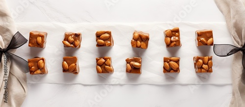 Handmade toffee caramel nut candy on crumpled paper Homemade food gifts for holidays Flat lay Copy space image Place for adding text or design