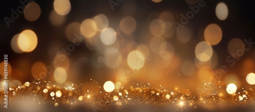 High quality photo of golden bokeh particles and highlights on a dark background for a festive abstract Christmas texture Copy space image Place for adding text or design