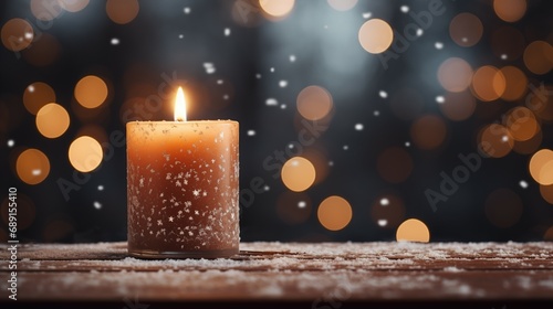 Candle in windowsill against on a background of snowy forest and snow-covered trees outside the window