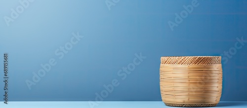 Eco friendly bamboo container on blue background promoting sustainable products and zero waste lifestyle Minimalistic with copy space Copy space image Place for adding text or design