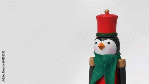 Closeup of figural penguin soldier Christmas nutcracker, isolated on copy-space background. photo