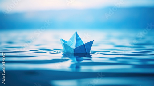 Paper boat floating on the water. Concept of leadership and success.