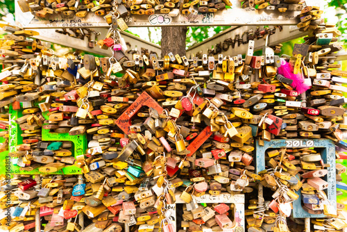 Paris, France - 23 February, 2023: Many wedding locks attached on a bridge