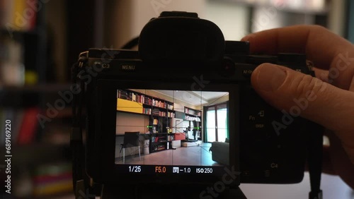 Man photographer taking pictures indoor in living room - real estate home photography and professional video to sell the house apartment - interior design and home staging