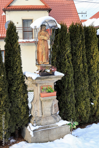 SPYTKOWICE, POLAND - DECEMBER 03,2023: A roadside shrine with figure of Jesus. photo