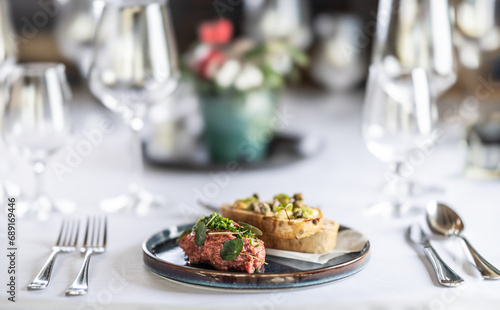 Steak Tartare with bread toasts served on a restaurant table